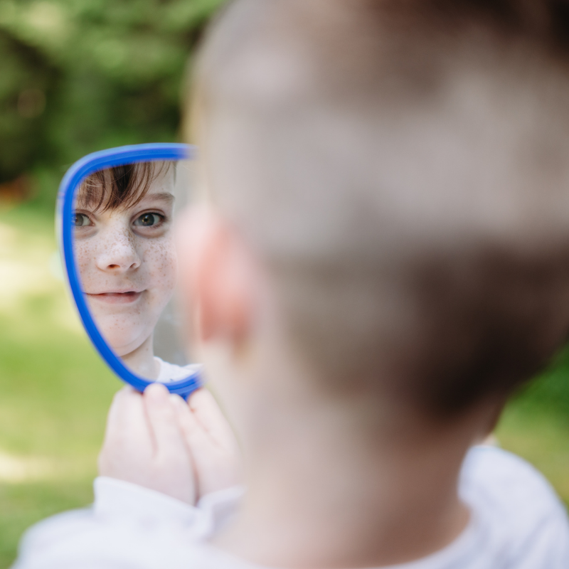 child learning body parts in mirror autism SEN